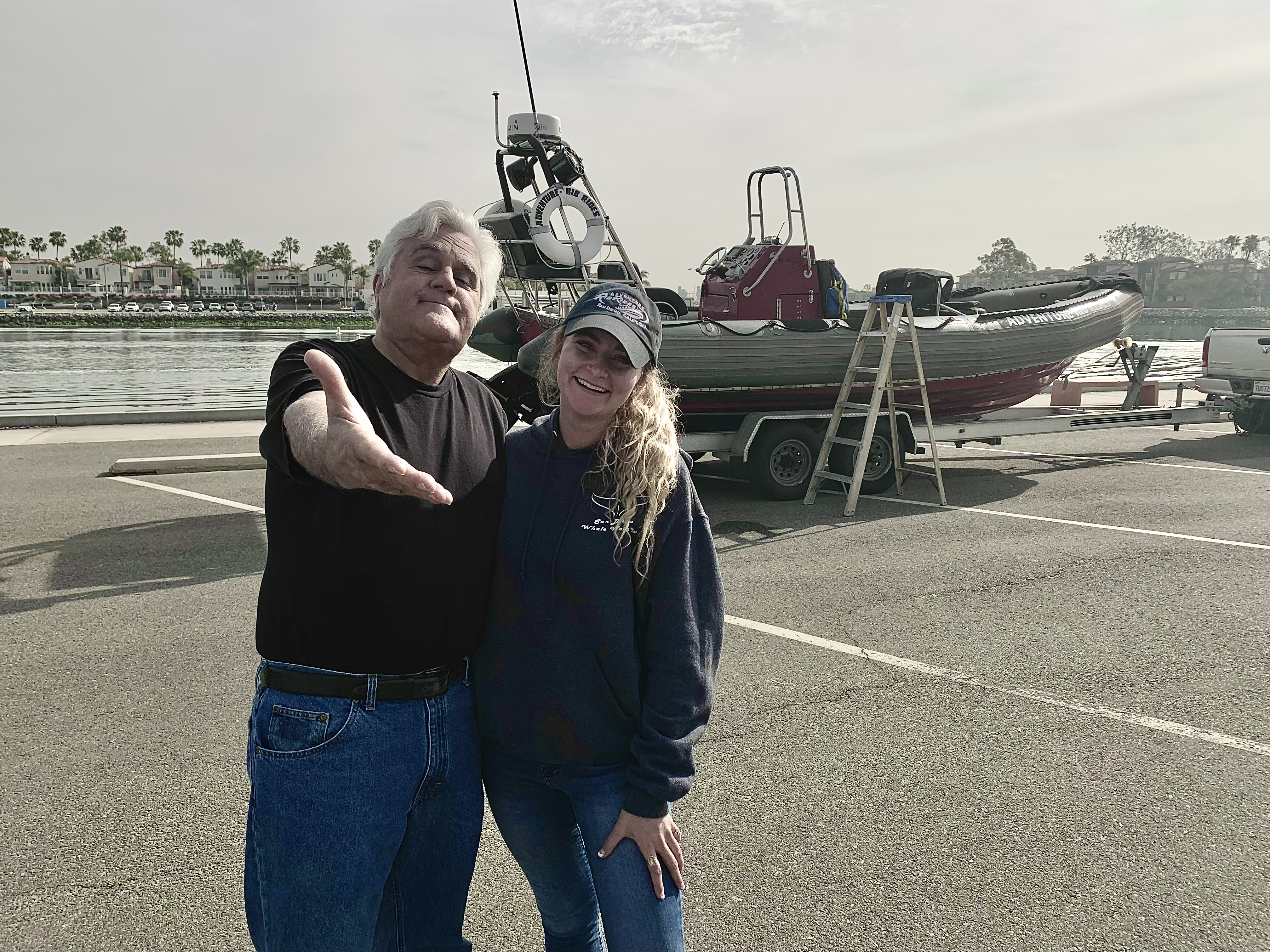 Jay Leno with Joann Camera boat showing camera man taking picture